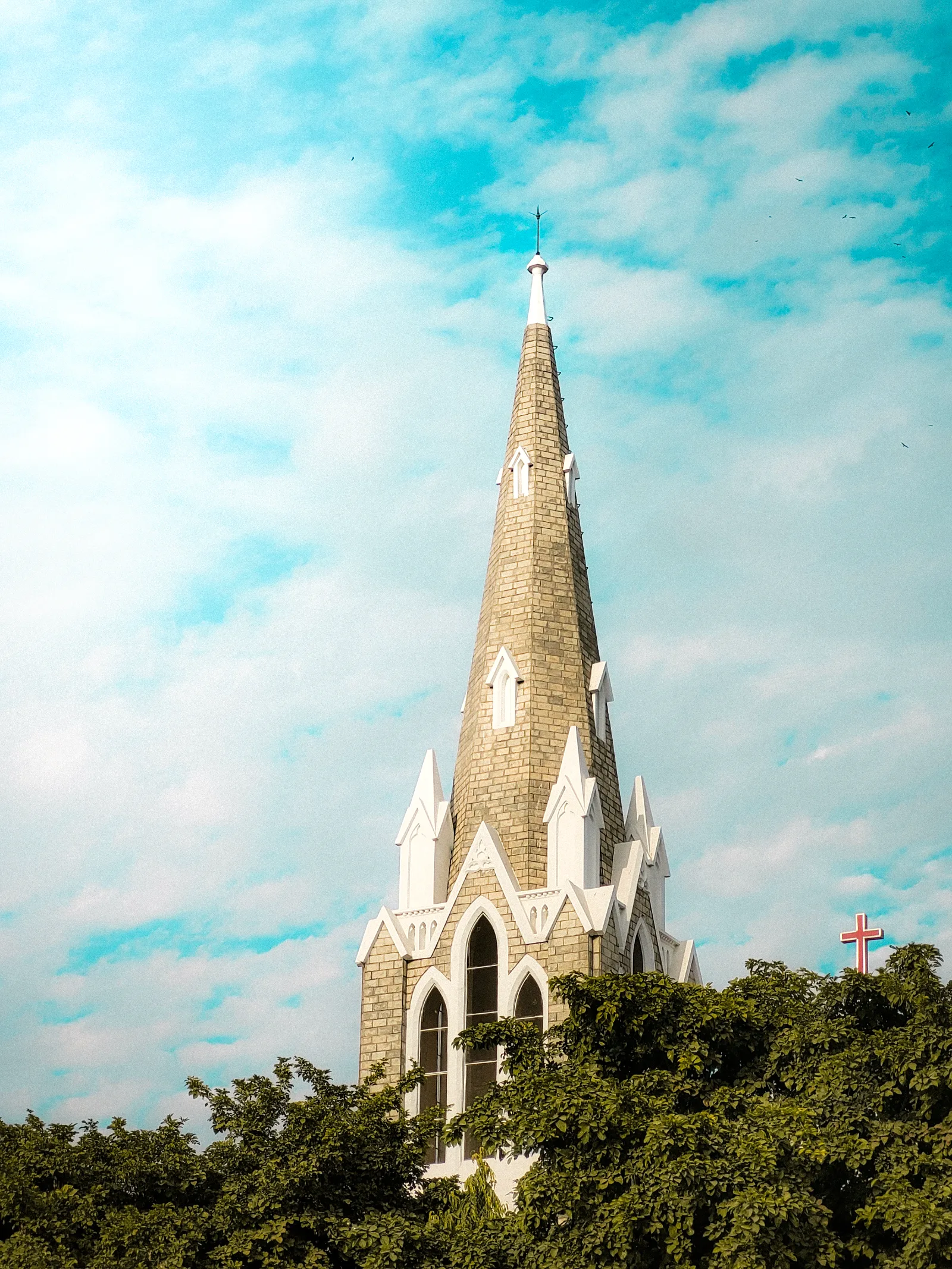 Brick spire against a bright clouded sky