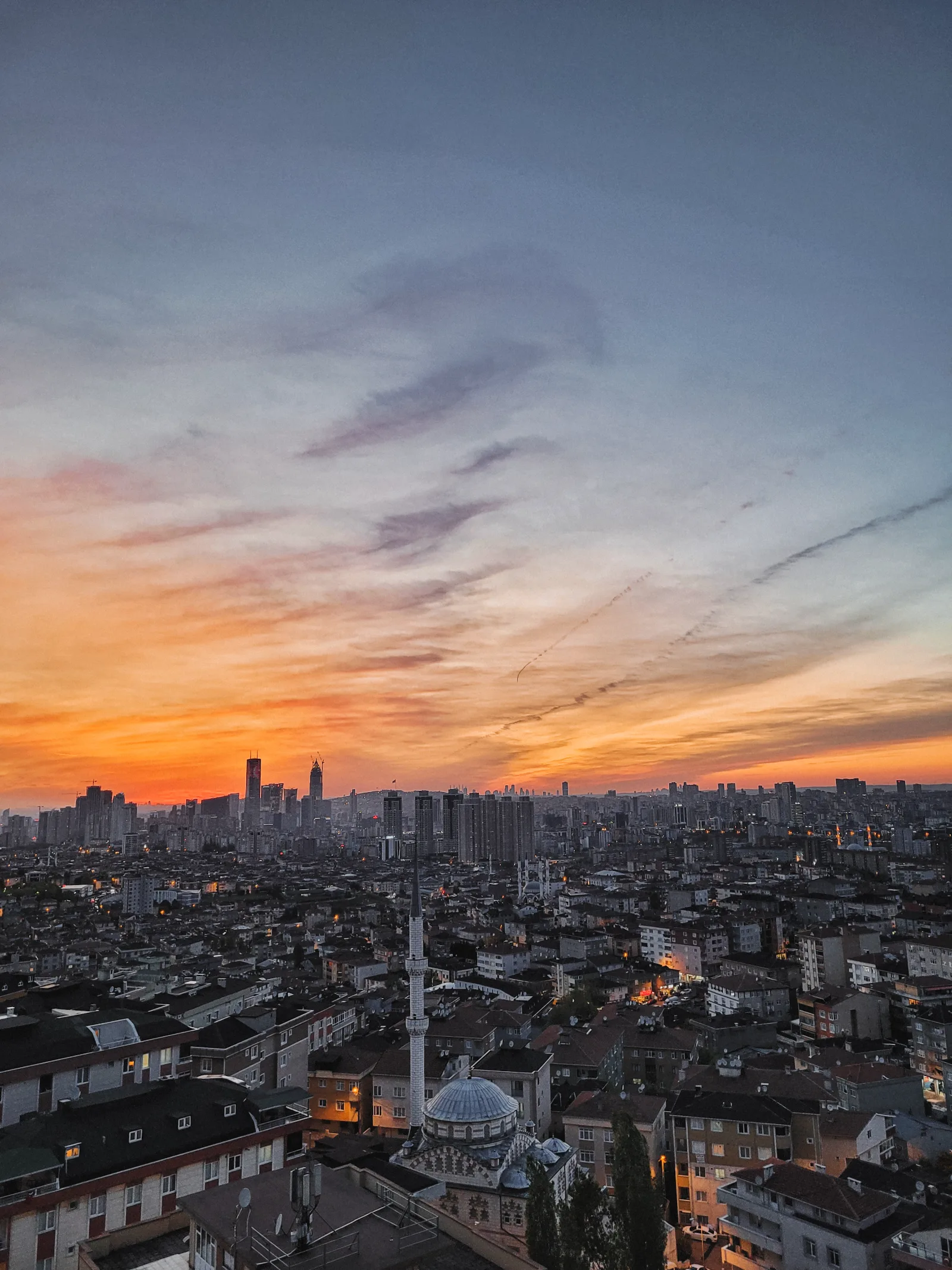 City rooftops and minaret at dusk