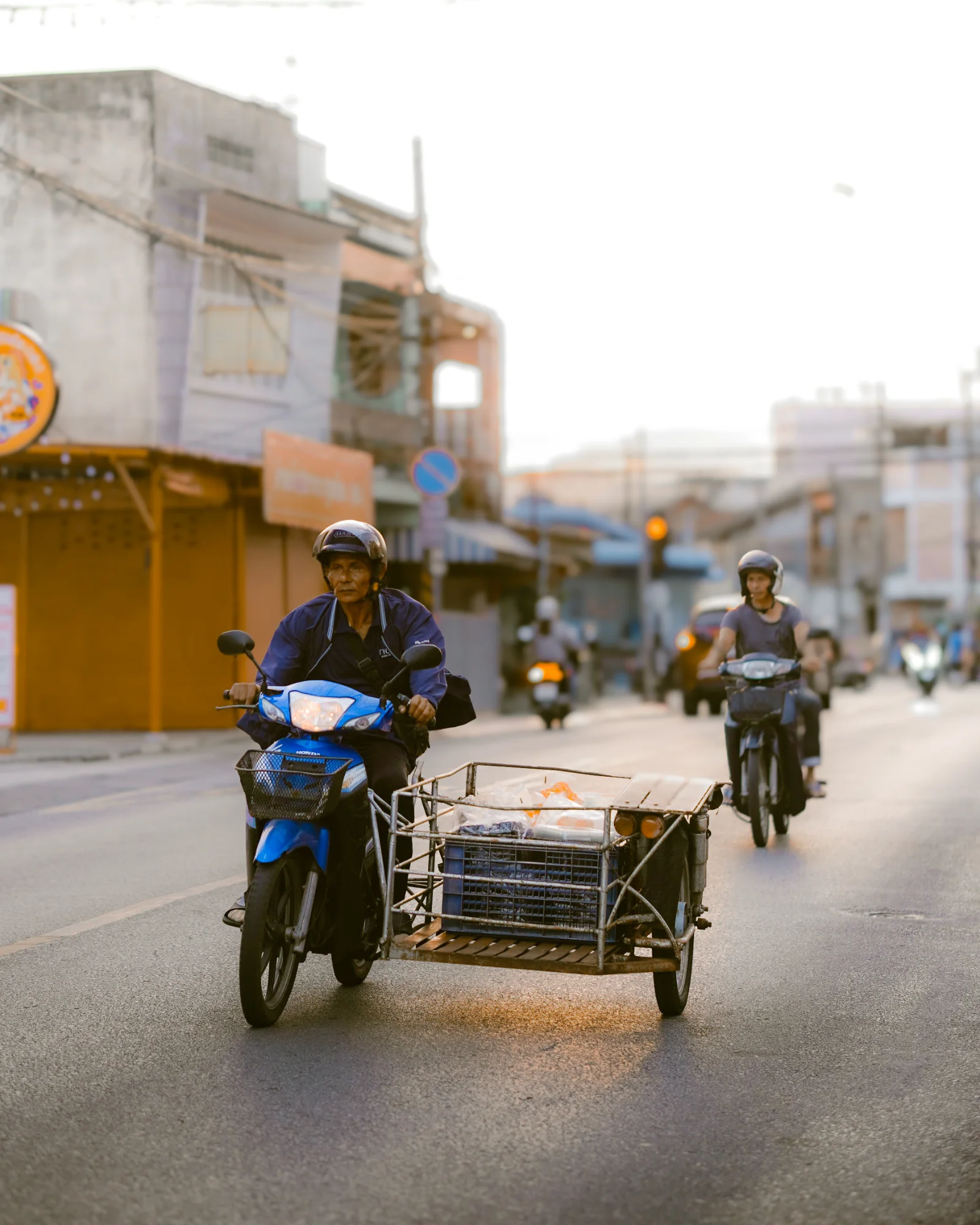 Motorbike sidecar crossing an empty street at dusk